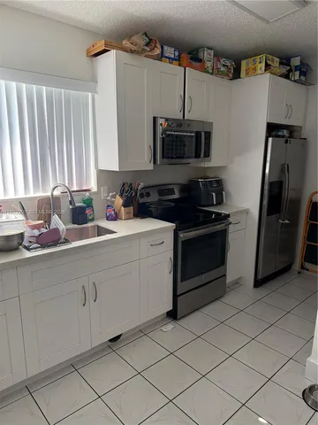 a view of a living room and a balcony