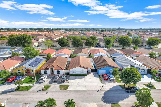 an aerial view of residential building with yard