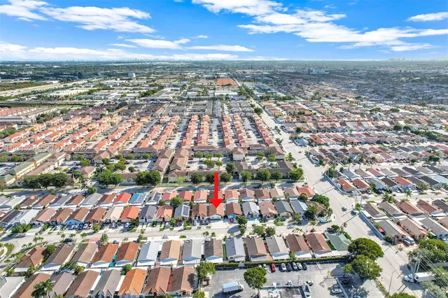 an aerial view of residential building with yard