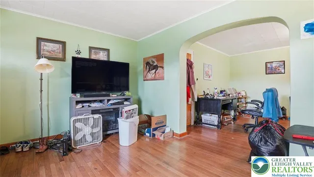 a room with furniture a flat screen tv and a table