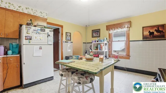 a bedroom with furniture and a large window
