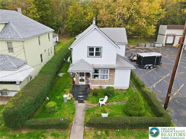 a aerial view of a house with table and chairs