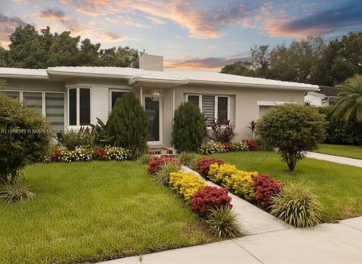 40 Southwest 30th Road Miami, FL 33129 - Photo 2 of 54 a front view of house with yard and outdoor seating