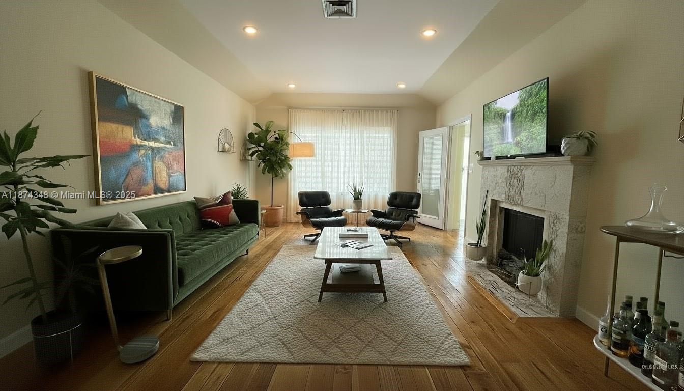 40 Southwest 30th Road Miami, FL 33129 - Photo 28 of 54 a living room with furniture a flat screen tv and a fireplace