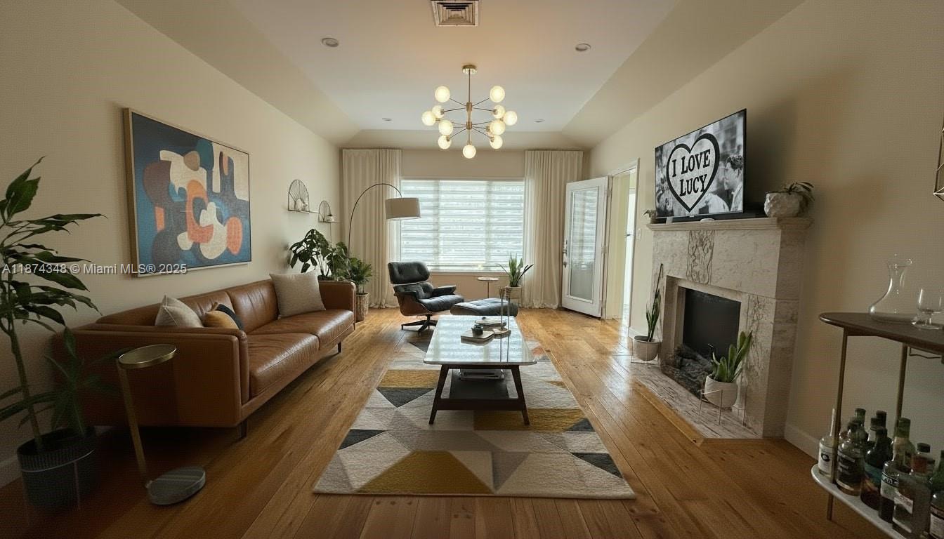 40 Southwest 30th Road Miami, FL 33129 - Photo 29 of 54 a living room with furniture a fireplace and a flat screen tv