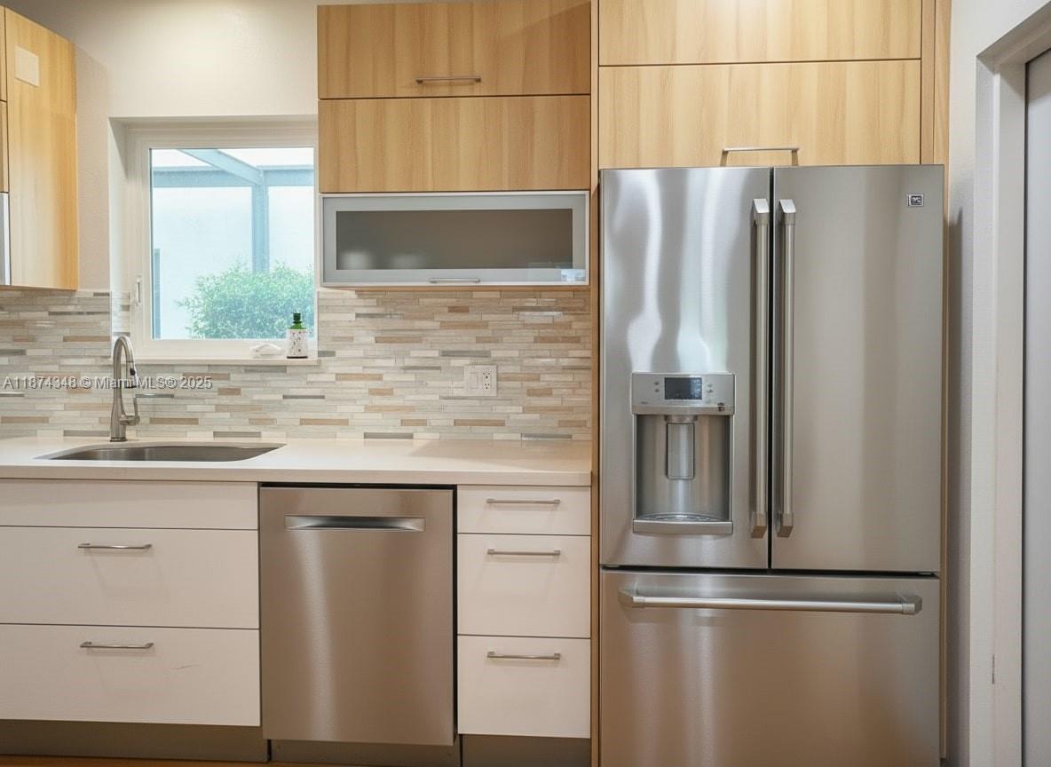 40 Southwest 30th Road Miami, FL 33129 - Photo 35 of 54 a kitchen with stainless steel appliances granite countertop a refrigerator and a sink
