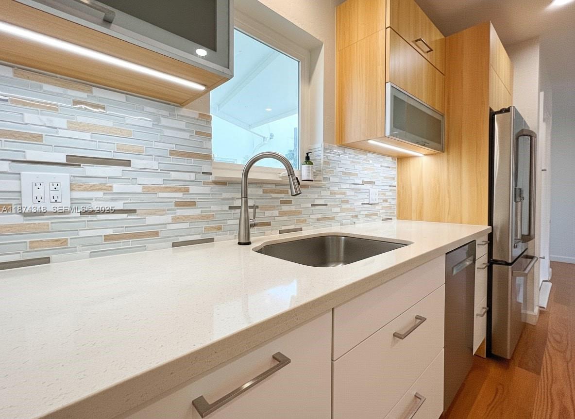 40 Southwest 30th Road Miami, FL 33129 - Photo 36 of 54 a kitchen with stainless steel appliances a sink and a refrigerator