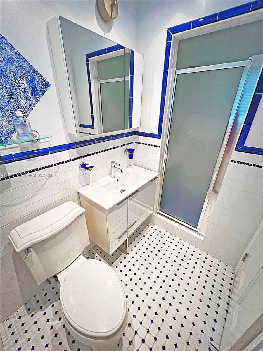40 Southwest 30th Road Miami, FL 33129 - Photo 39 of 54 a bathroom with a toilet a sink and a mirror