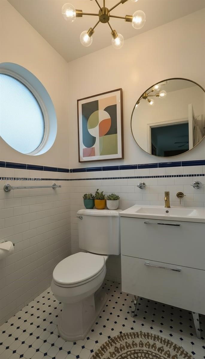 40 Southwest 30th Road Miami, FL 33129 - Photo 40 of 54 a bathroom with a toilet a sink and mirror