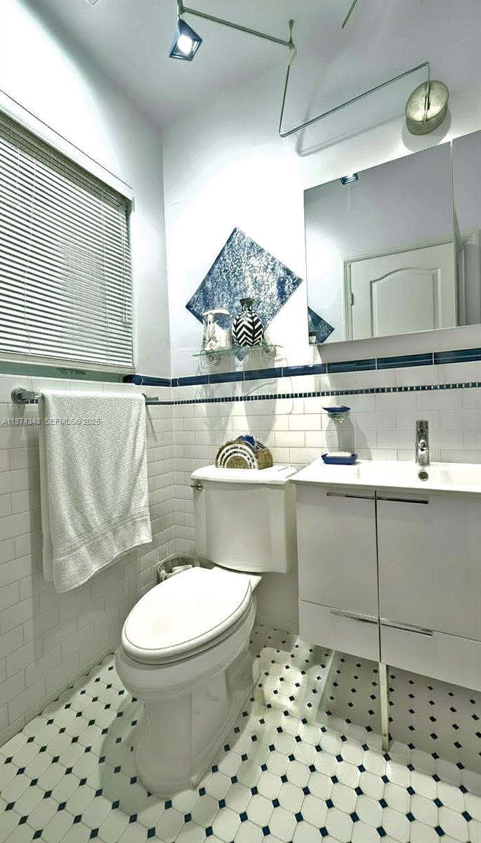 40 Southwest 30th Road Miami, FL 33129 - Photo 41 of 54 a bathroom with a sink a toilet and a mirror