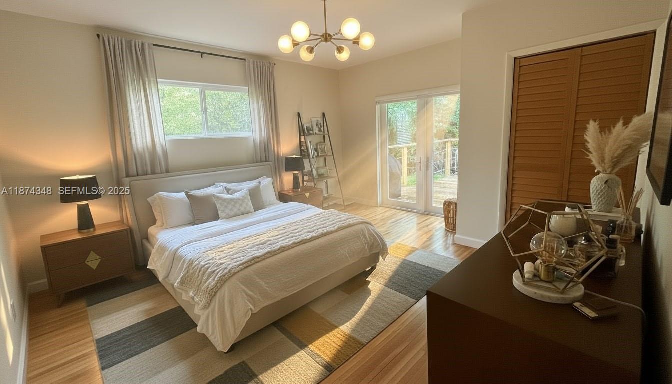 40 Southwest 30th Road Miami, FL 33129 - Photo 10 of 54 a bedroom with a bed and a chandelier