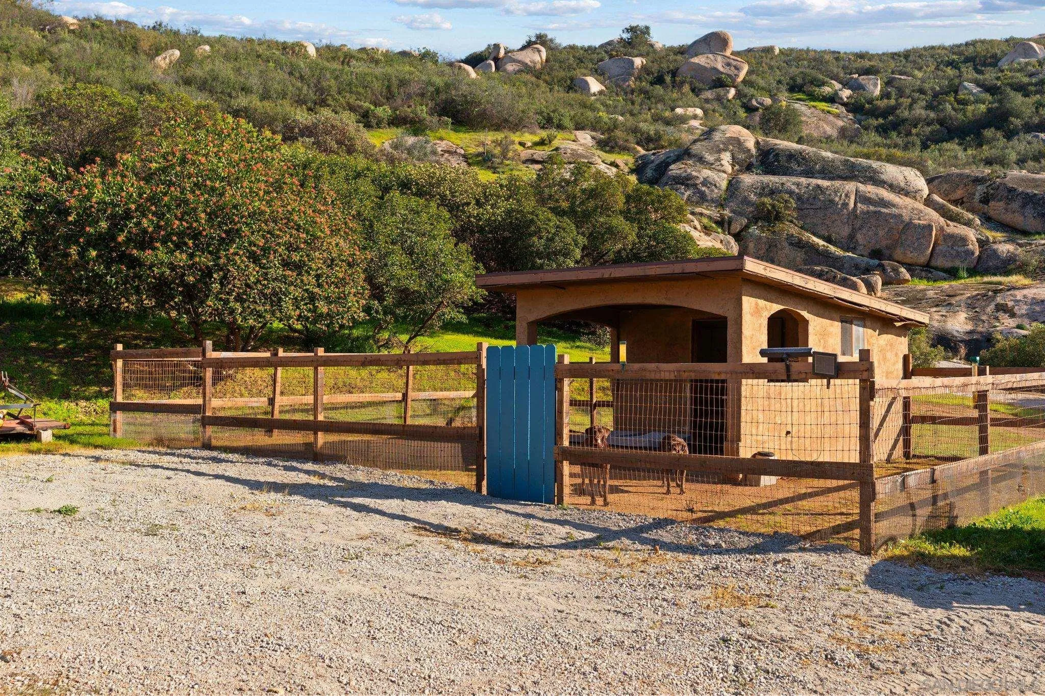 19491 Deerhorn Valley Road Jamul, CA 91935 - Photo 60 of 75 a view of a small house with wooden fence