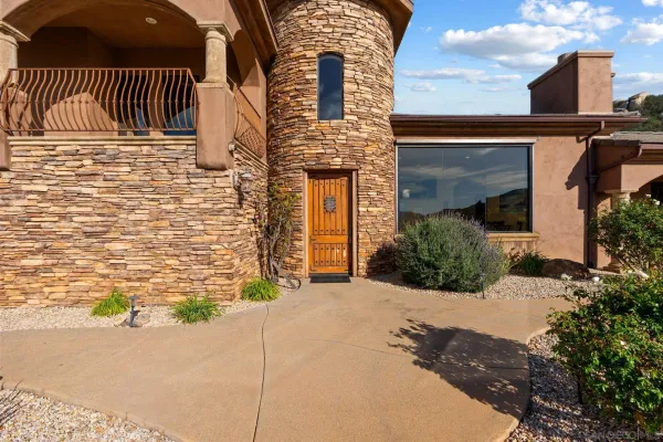 a bathroom with a granite countertop sink a toilet and a mirror