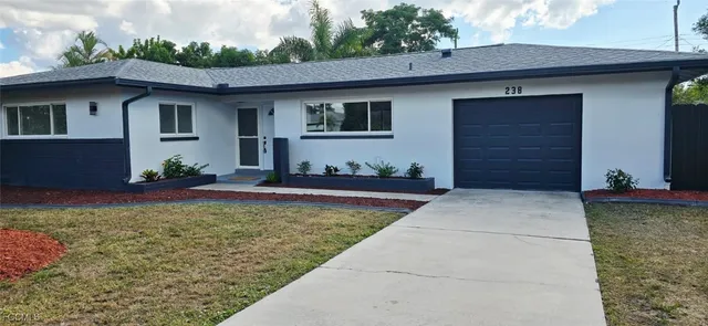 a front view of house with yard outdoor seating and barbeque oven
