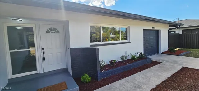a large white kitchen with white cabinets and stainless steel appliances