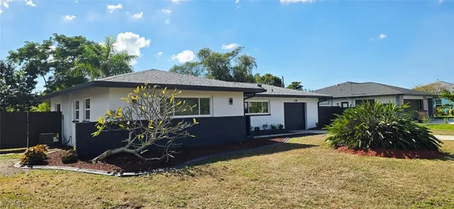 a view of a hallway with wooden floor and a living room