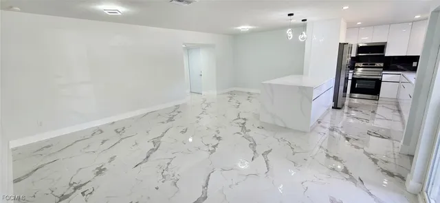 a view of a kitchen with a sink and a stove top oven