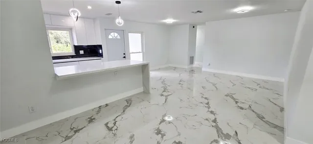 a kitchen with stainless steel appliances granite countertop a refrigerator and a stove top oven