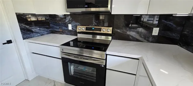 a kitchen with a sink and large window