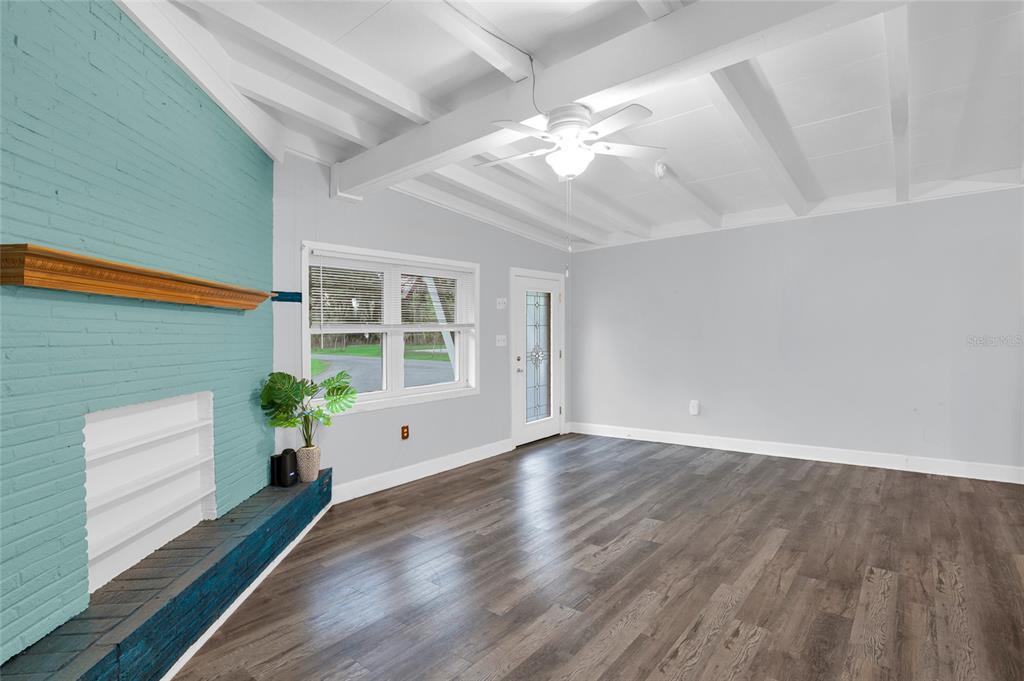 2313 River Ridge Road DeLand, FL 32720 - Photo 11 of 63 a view of an empty room with wooden floor and a window