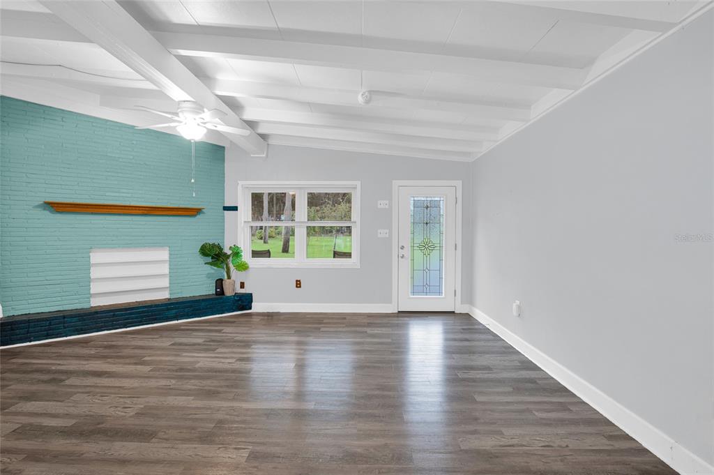 2313 River Ridge Road DeLand, FL 32720 - Photo 12 of 63 a view of an empty room with a window and wooden floor
