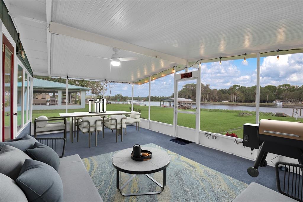 2313 River Ridge Road DeLand, FL 32720 - Photo 33 of 63 a living room with furniture and a floor to ceiling window