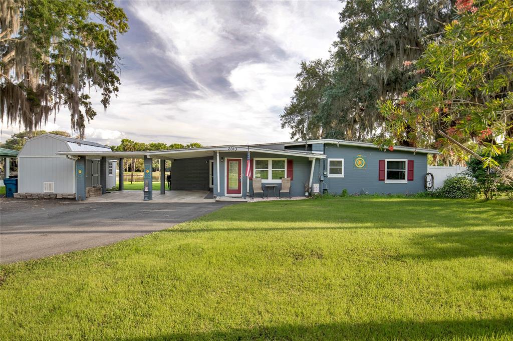 2313 River Ridge Road DeLand, FL 32720 - Photo 5 of 63 a front view of a house with a garden
