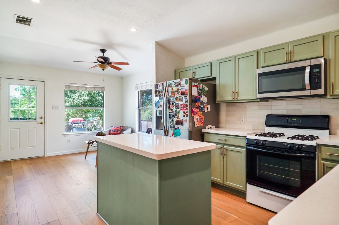 1422 Wheatfall Lane Austin, TX 78748 - Photo 11 of 29 a kitchen with a sink stove and microwave