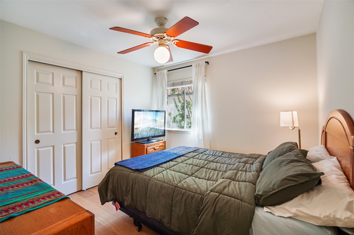 1422 Wheatfall Lane Austin, TX 78748 - Photo 15 of 29 a bedroom with a bed and a chandelier