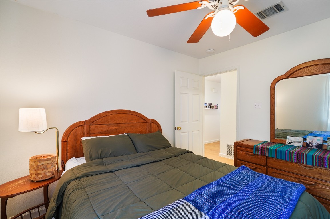 1422 Wheatfall Lane Austin, TX 78748 - Photo 16 of 29 a bedroom with 2 bed and a chandelier