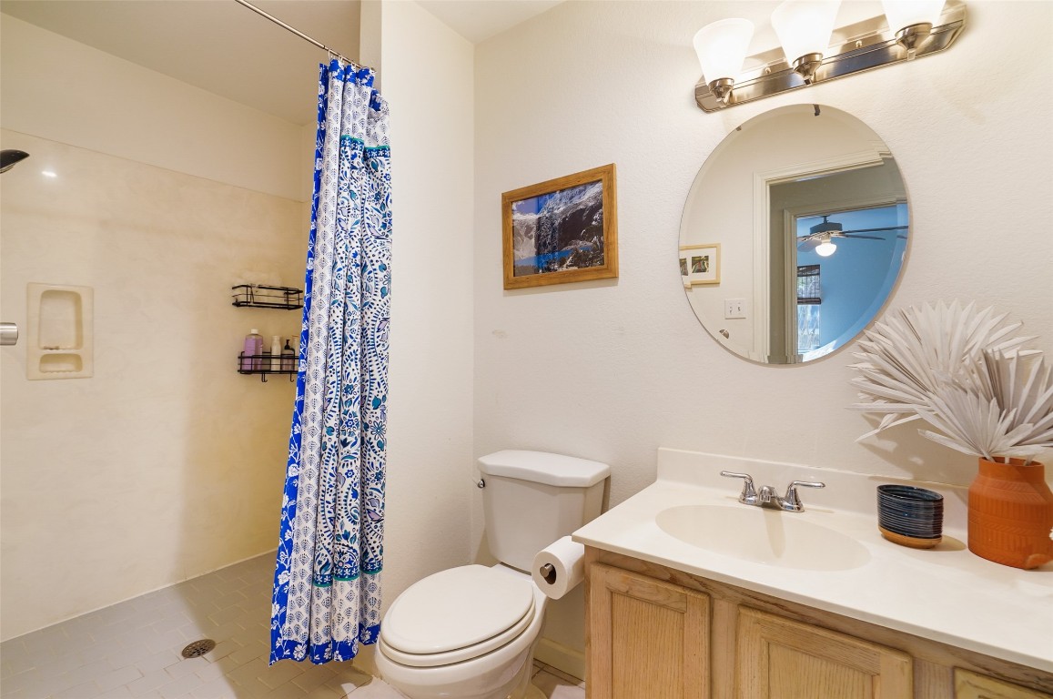 1422 Wheatfall Lane Austin, TX 78748 - Photo 17 of 29 a bathroom with a sink a toilet and shower curtain