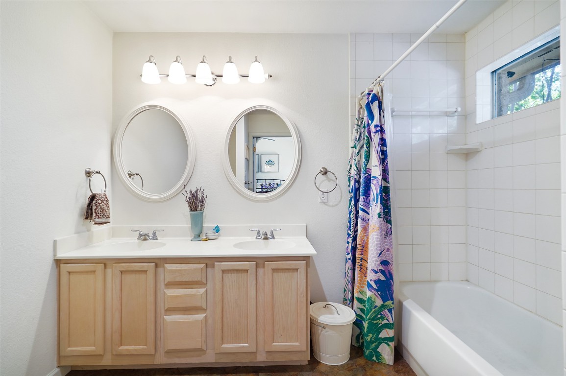 1422 Wheatfall Lane Austin, TX 78748 - Photo 21 of 29 a bathroom with a sink mirror toilet and a bathtub