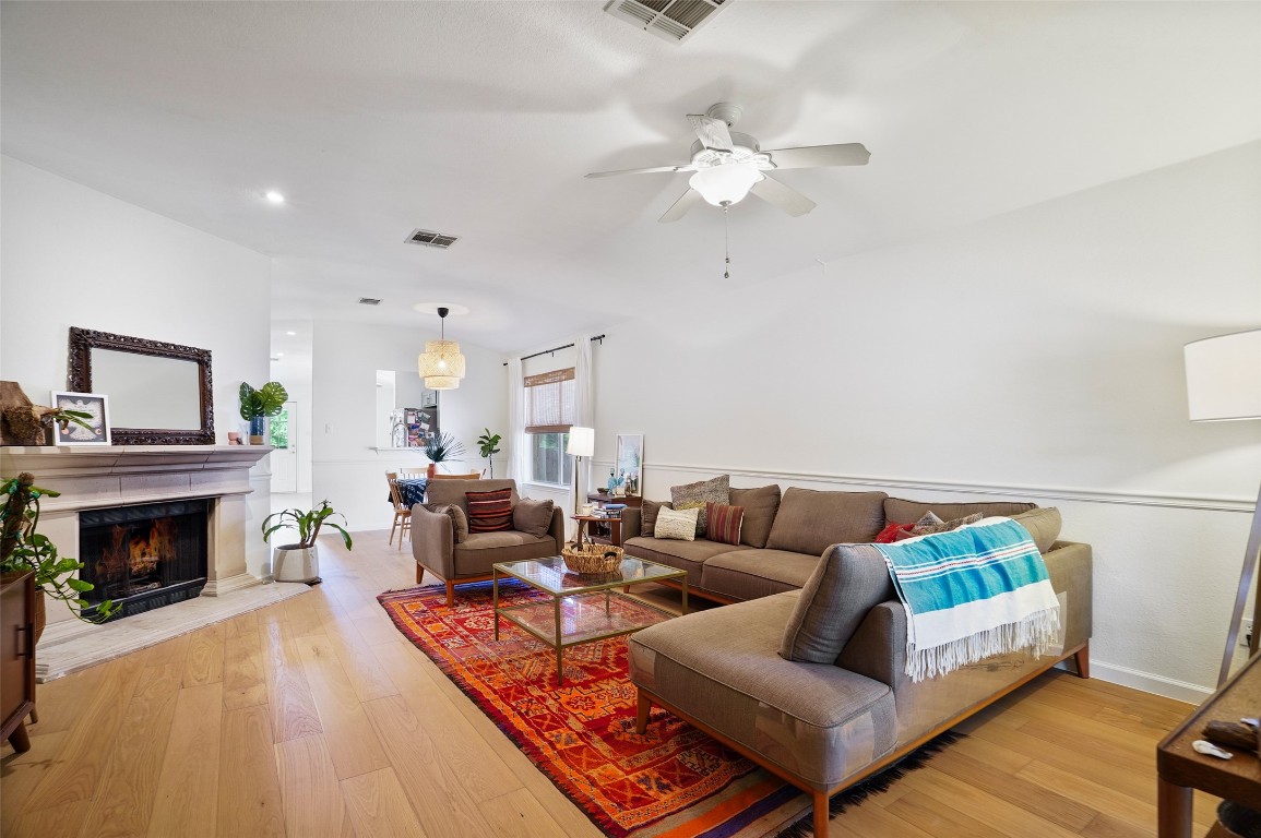1422 Wheatfall Lane Austin, TX 78748 - Photo 6 of 29 a living room with furniture and a fireplace