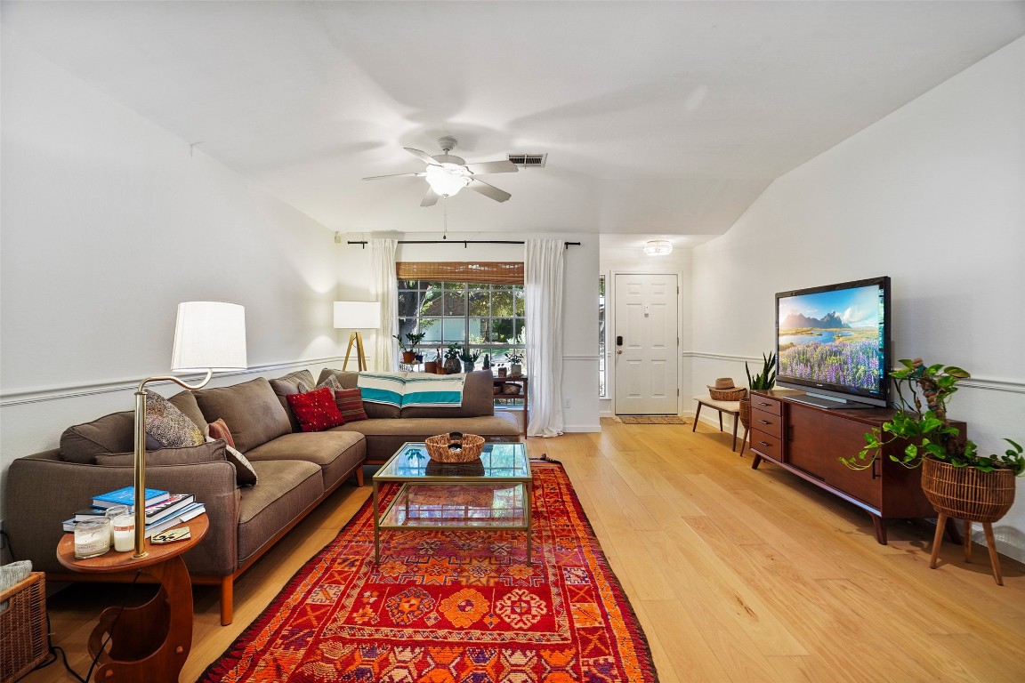 1422 Wheatfall Lane Austin, TX 78748 - Photo 7 of 29 a living room with furniture and a flat screen tv