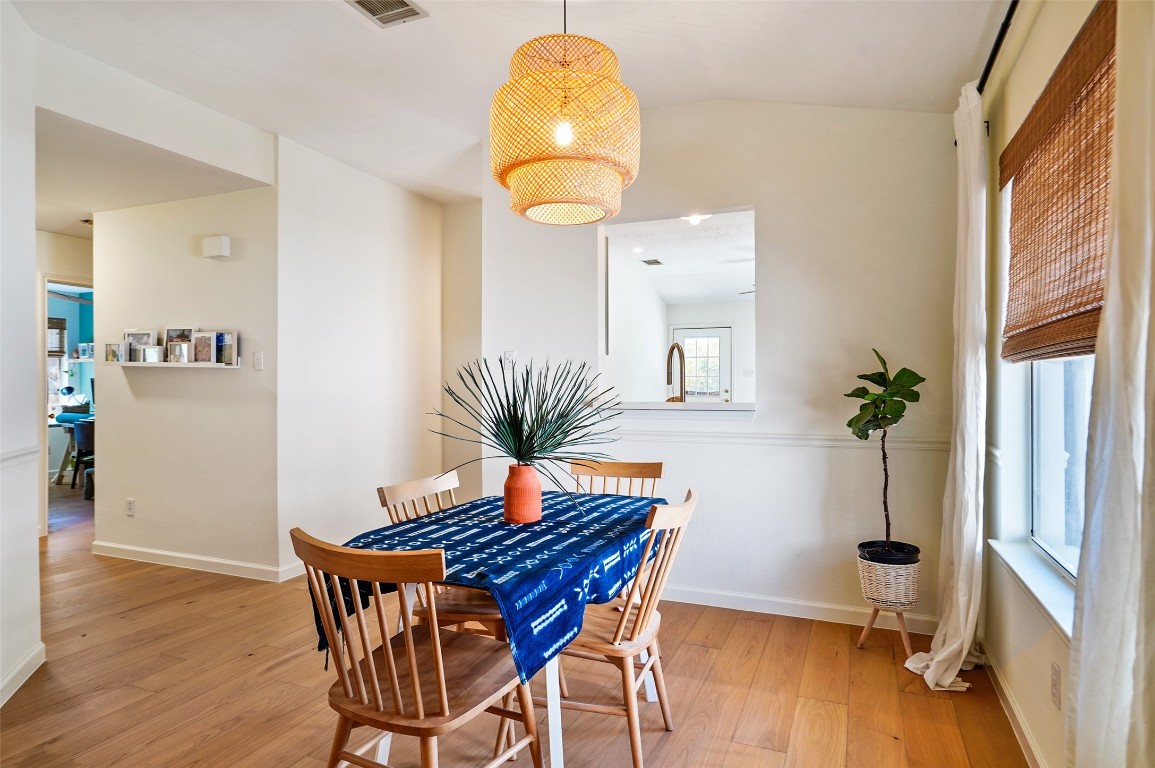 1422 Wheatfall Lane Austin, TX 78748 - Photo 10 of 29 a view of a dining room with furniture and wooden floor