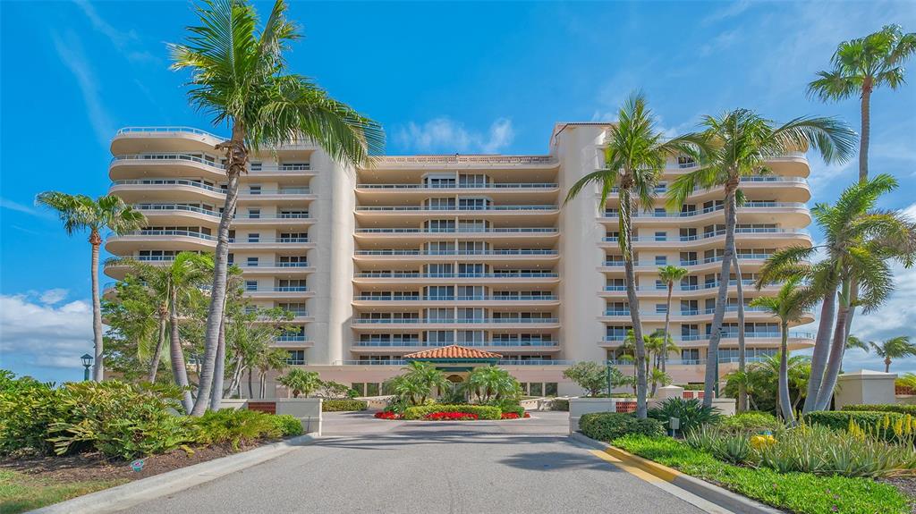 3060 Grand Bay Boulevard, Unit 155 Longboat Key, FL 34228 - Photo 1 of 67 a front view of multi story residential apartment building with yard and sign board