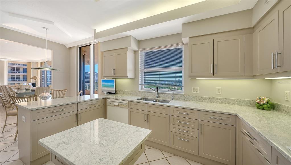 3060 Grand Bay Boulevard, Unit 155 Longboat Key, FL 34228 - Photo 14 of 67 a kitchen with a sink stove and cabinets