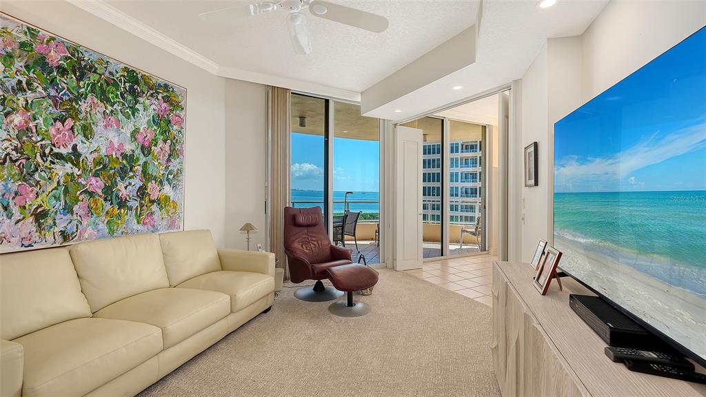 3060 Grand Bay Boulevard, Unit 155 Longboat Key, FL 34228 - Photo 16 of 67 a living room with furniture and a floor to ceiling window