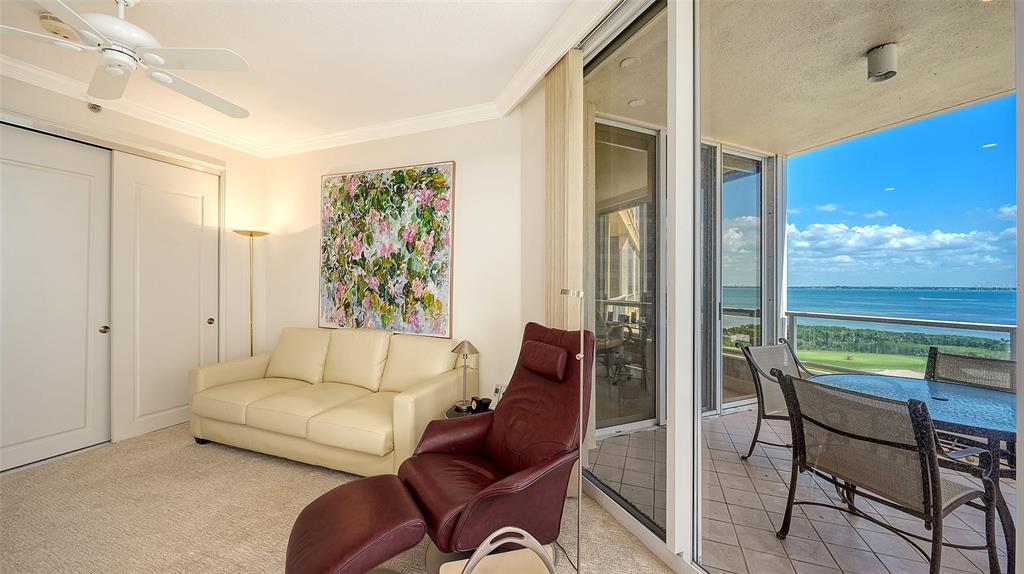 3060 Grand Bay Boulevard, Unit 155 Longboat Key, FL 34228 - Photo 17 of 67 a living room with furniture and a large window