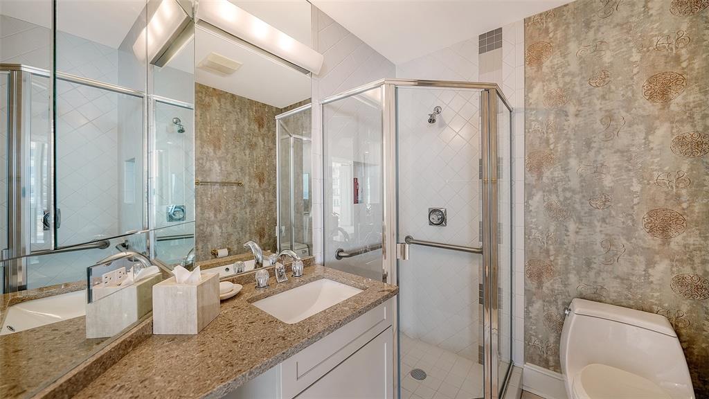 3060 Grand Bay Boulevard, Unit 155 Longboat Key, FL 34228 - Photo 18 of 67 a bathroom with a granite countertop double vanity sink mirror and shower