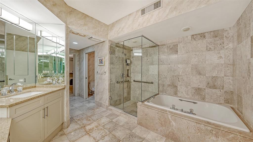 3060 Grand Bay Boulevard, Unit 155 Longboat Key, FL 34228 - Photo 23 of 67 a bathroom with a tub sink toilet and a shower