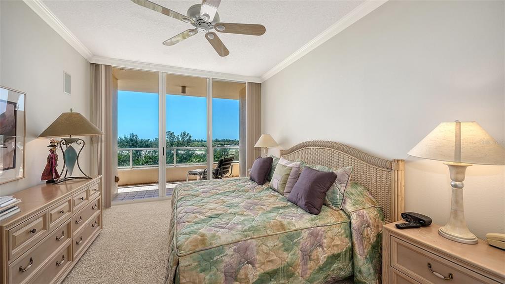 3060 Grand Bay Boulevard, Unit 155 Longboat Key, FL 34228 - Photo 24 of 67 a bedroom with a bed and a chandelier