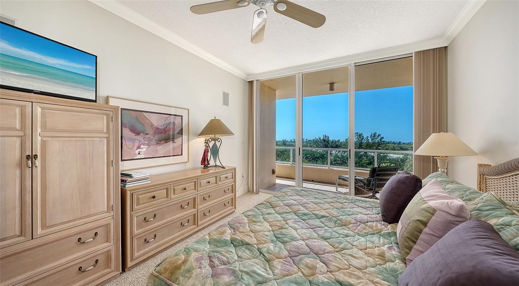 3060 Grand Bay Boulevard, Unit 155 Longboat Key, FL 34228 - Photo 25 of 67 a living room with furniture and a flat screen tv