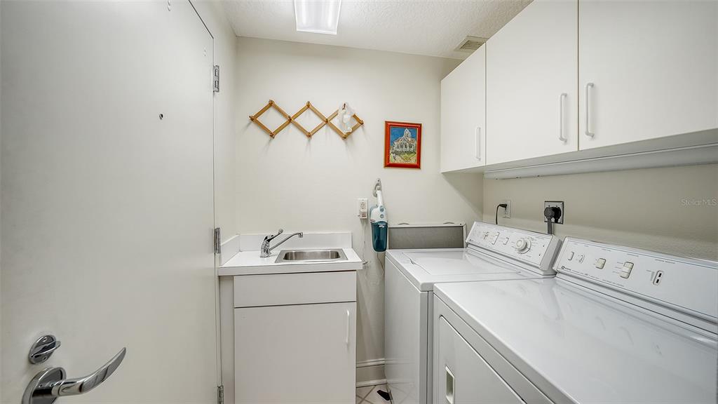 3060 Grand Bay Boulevard, Unit 155 Longboat Key, FL 34228 - Photo 28 of 67 a utility room with dryer and washer
