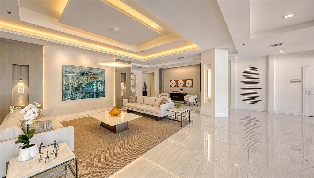 3060 Grand Bay Boulevard, Unit 155 Longboat Key, FL 34228 - Photo 39 of 67 a living room with furniture and a table