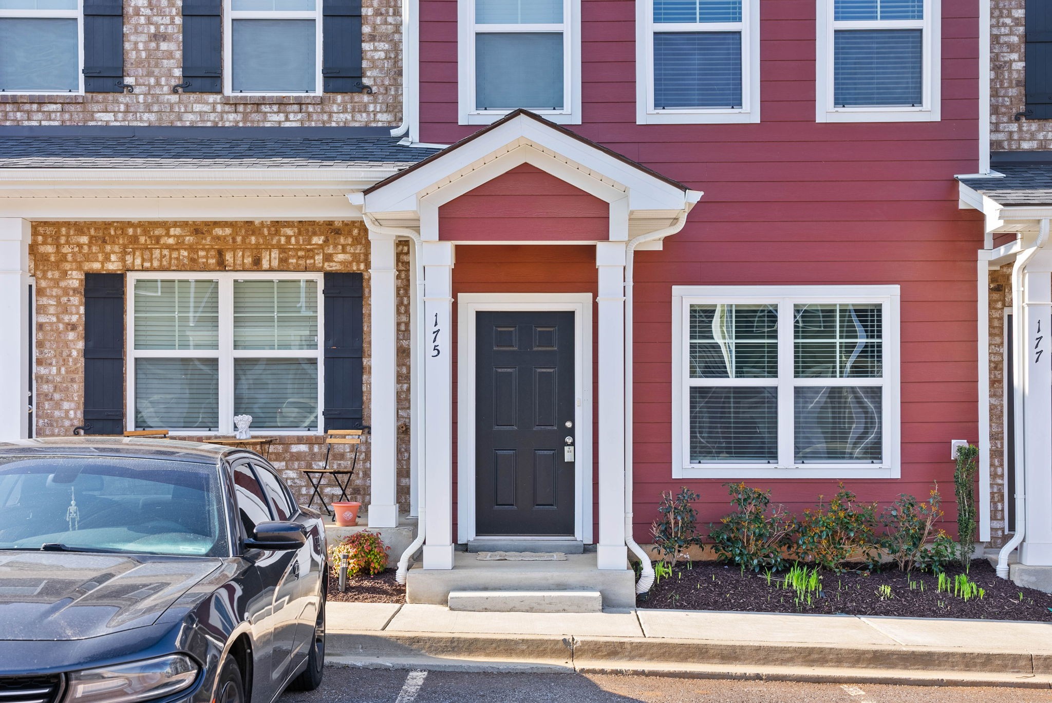 a front view of a house with a yard and sitting area