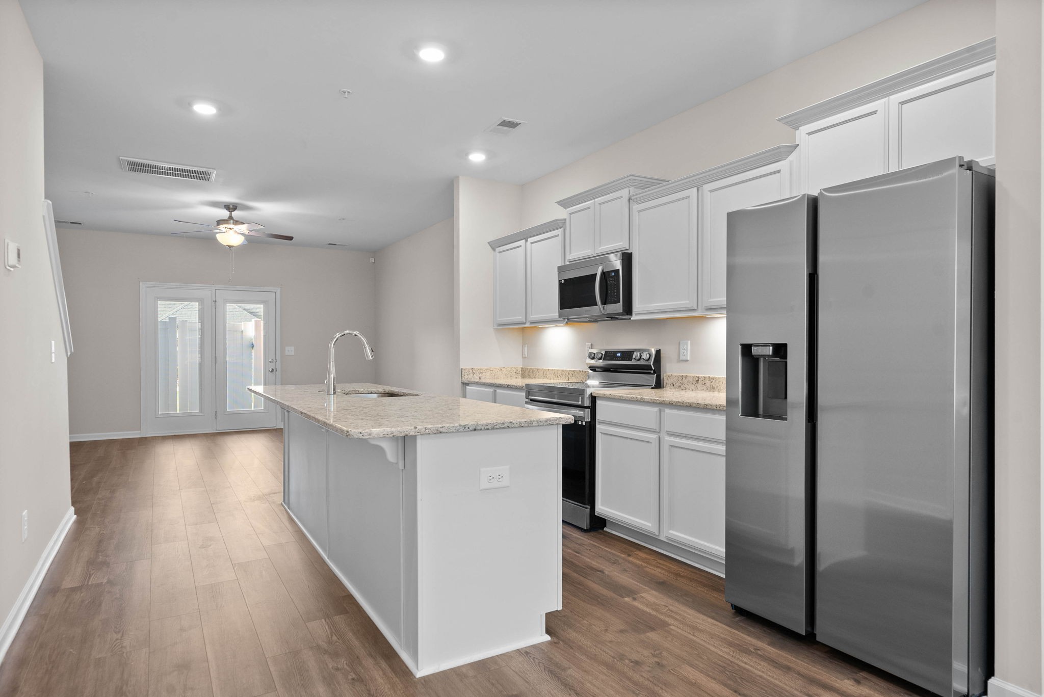 175 Addi Street Pleasant View, TN 37146 - Photo 6 of 22 a kitchen with refrigerator cabinets and wooden floor