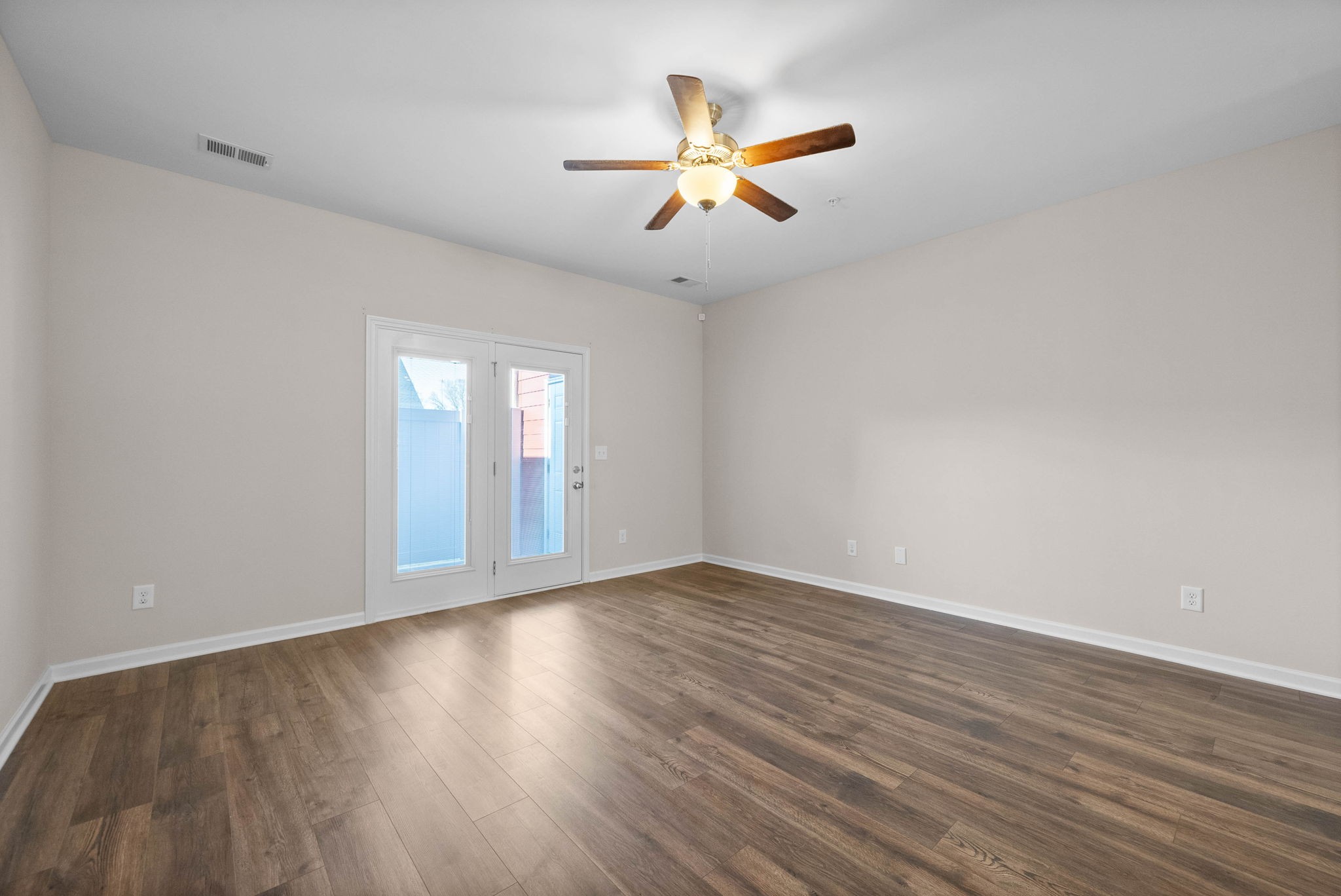 175 Addi Street Pleasant View, TN 37146 - Photo 10 of 22 a view of an empty room with wooden floor and a window
