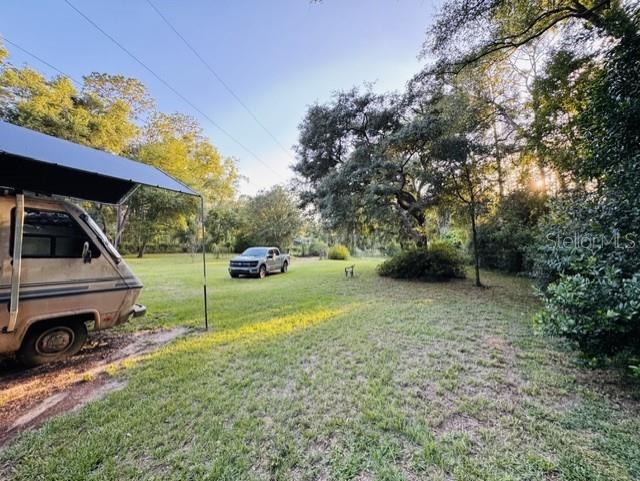 11817 Southwest 58th Street Webster, FL 33597 - Photo 34 of 46 a view of a backyard with a car parked