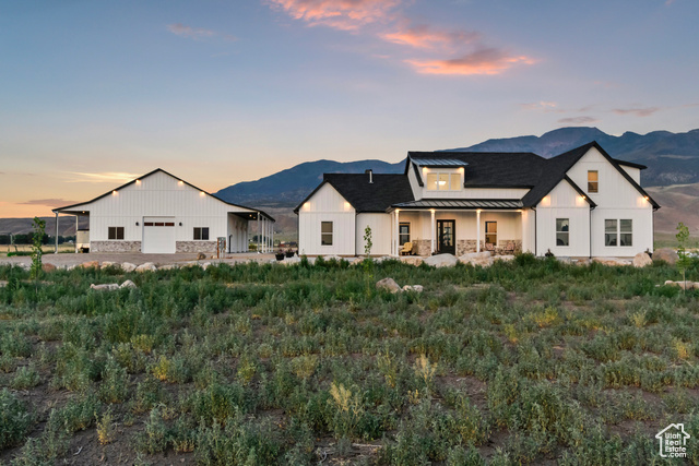 1952 Highway 118 Monroe, UT 84754 - Photo 63 of 88 View of front of home with a standing seam roof, a mountain view, and board and batten siding